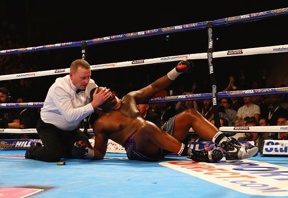 LONDON, ENGLAND - DECEMBER 12: the referee assists Dillian Whyte as he clings to the ropes after being knocked down by Anthony Joshua in the seventh round during the British and Commonwealth heavyweight title contest at The O2 Arena on December 12, 2015 in London, England. (Photo by Richard Heathcote/Getty Images)
