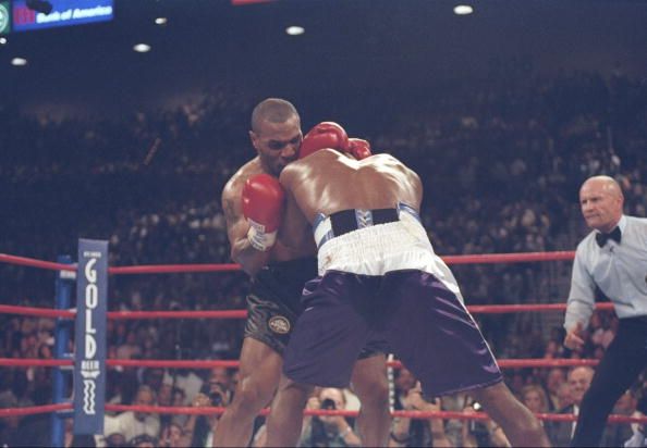 28 Jun 1997: Evander Holyfield and Mike Tyson lock heads during their heavyweight title fight at the MGM Grand Garden in Las Vegas, Nevada. Holyfield won the fight when Tyson was disqualified in the third round for biting Holyfield twice. Mandatory Cr