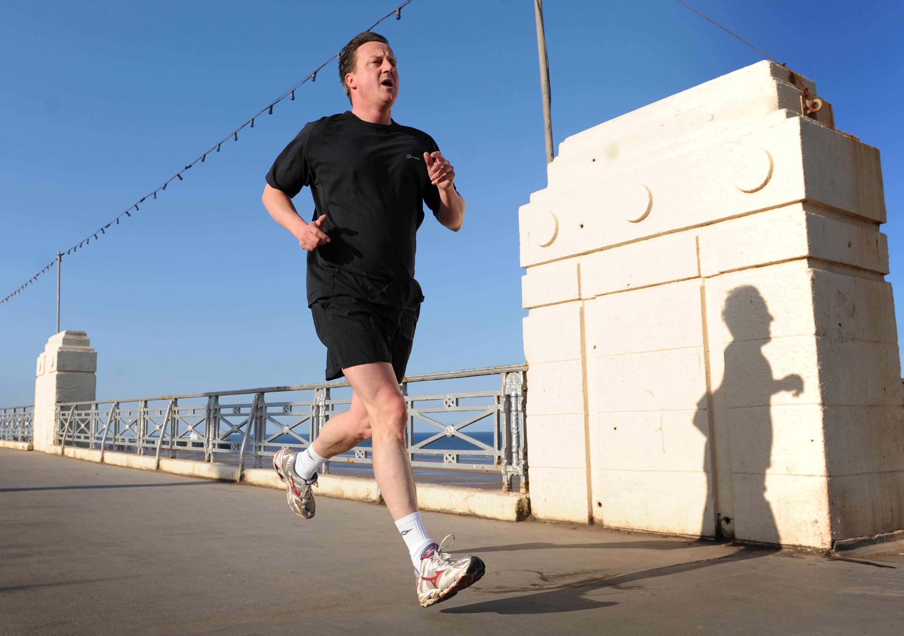 BLACKPOOL, UNITED KINGDOM - MAY 3:  Conservative Party leader David Cameron runs along the seafront in Blackpool on May 3, 2010 in North West England. The General Election, to be held on May 6, 2010 is set to be one of the most closely fought political contests in recent times with all main party leaders embarking on a four week campaign to win the votes of the United Kingdom. (Photo by Stefan Rousseau - WPA Pool / Getty Images) *** Local Caption *** David Cameron