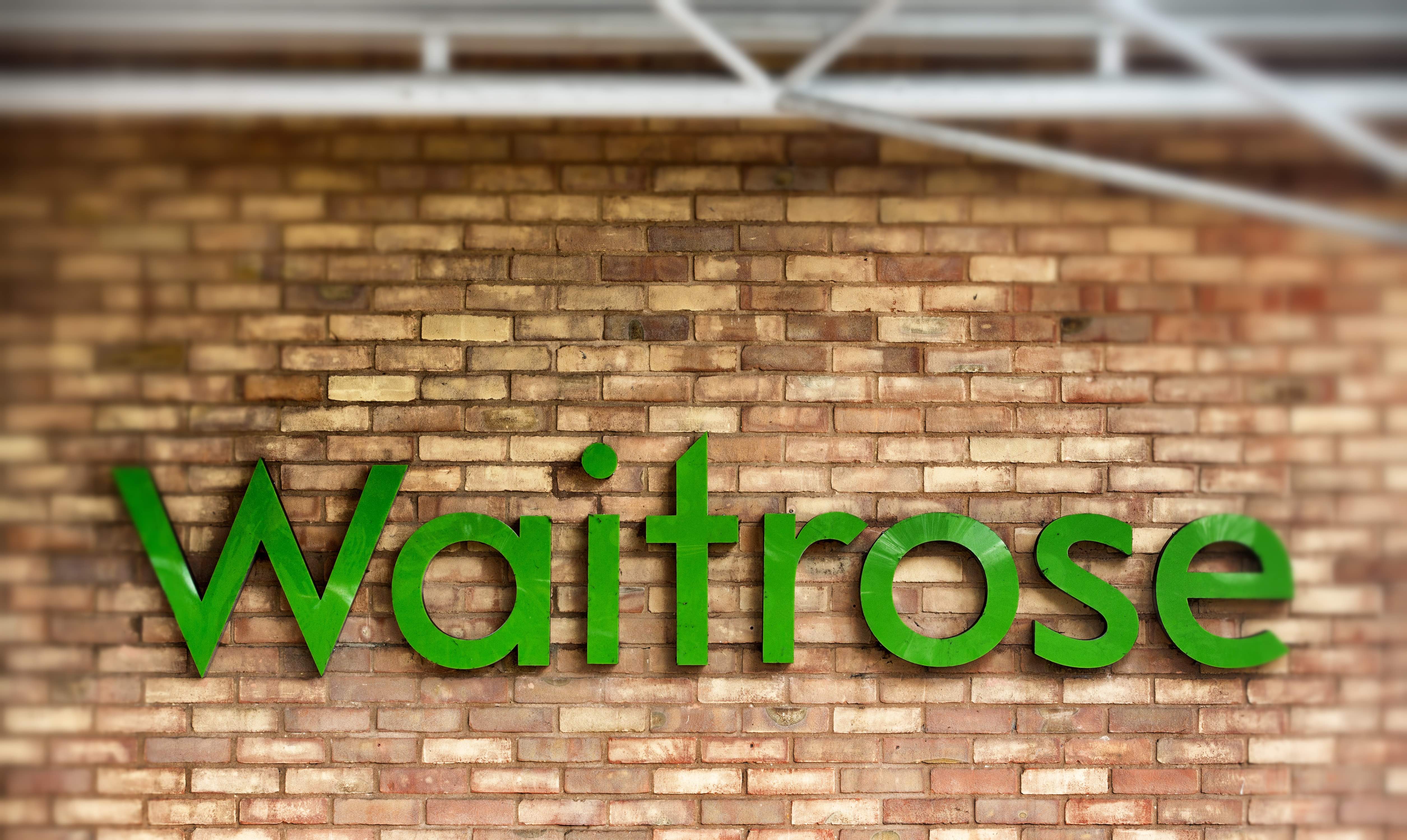 BRISTOL, ENGLAND - NOVEMBER 18: (EDITORS NOTE: This image was created using digital filters) The Waitrose sign is displayed outside a branch of the supermarket on November 18, 2015 in Bristol, England. As the crucial Christmas retail period approaches, all the major supermarkets are becoming increasingly competitive to retain and increase their share of the market. (Photo by Matt Cardy/Getty Images)
