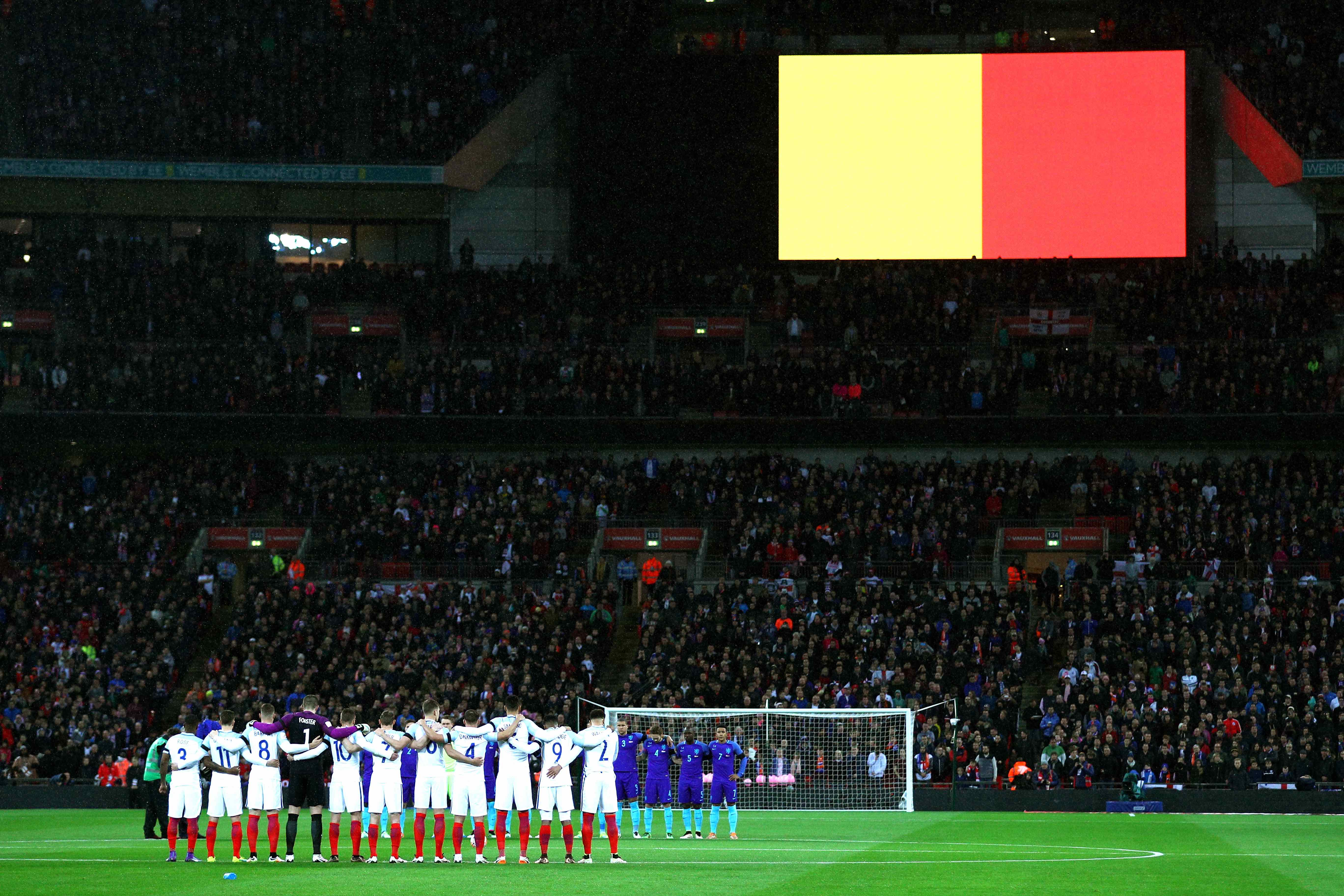 LONDON, ENGLAND - MARCH 29:  England and Netherlands players observe a minute of silence for the victims of Brussels terror attacks as the Belgium flag is shown on big screen prior to the International Friendly match between England and Netherlands at Wembley Stadium on March 29, 2016 in London, England.  (Photo by Paul Gilham/Getty Images)
