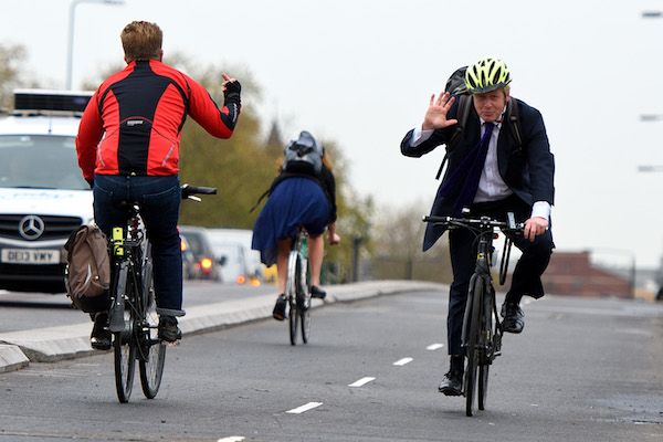 LONDON, ENGLAND - NOVEMBER 19: A cyclist makes a hand gesture to Mayor of London Boris Johnson as he cycles over Vauxhall Bridge to launch London's first cycle superhighway on November 19, 2015 in London, England. Superhighway 5 (CS5) is the capital's first two lane fully segregated cycle superhighway. (Photo by Ben Pruchnie/Getty Images)