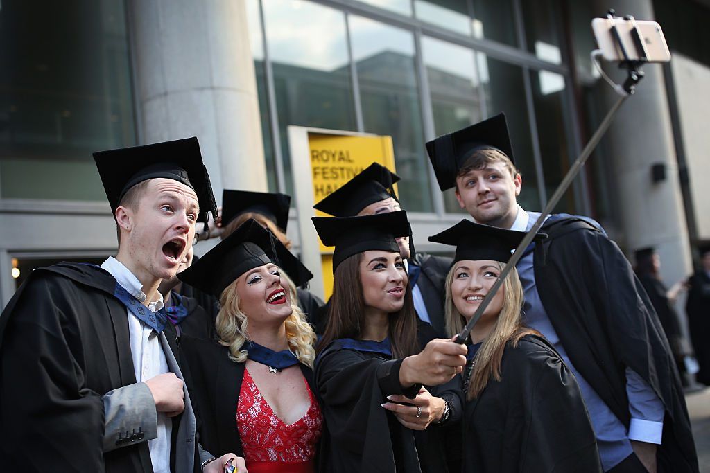 LONDON, ENGLAND - OCTOBER 13: Students take a selfie ahead of their graduation ceremony at the Royal Festival Hall on October 13, 2015 in London, England. Students of the London South Bank University's School of Arts and Creative Industries attended their graduation ceremony at the Royal Festival Hall today. (Photo by Dan Kitwood/Getty Images)