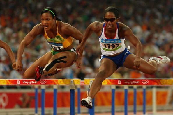 BEIJING - AUGUST 18: (L-R) Bridgitte Foster-Hylton of Jamaica and Sarah Claxton of Great Britain compete in the Women's 100m Hurdles Semi Final at the National Stadium on Day 10 of the Beijing 2008 Olympic Games on August 18, 2008 in Beijing, China. (Photo by Stu Forster/Getty Images)