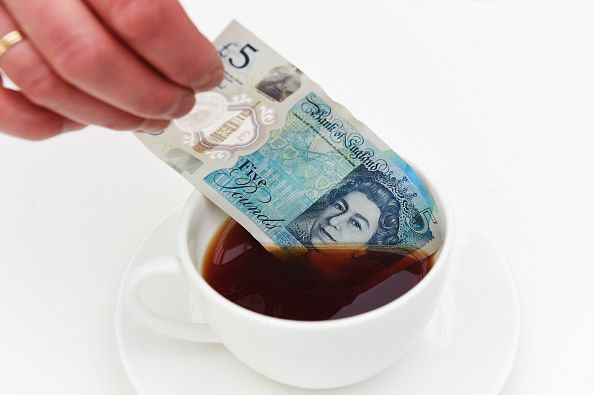 WOODSTOCK, ENGLAND - JUNE 02: The new polymer £5 note featuring Sir Winston Churchill is dipped in liquid as it is unveiled at Blenheim Palace on June 2, 2016 in Woodstock, England. The new fiver will be issued in September, and in a break from the current paper notes it will be printed on polymer, a thin flexible plastic film, which is seen as more durable and more secure. (Photo by Joe Giddens - WPA Pool/Getty Images)