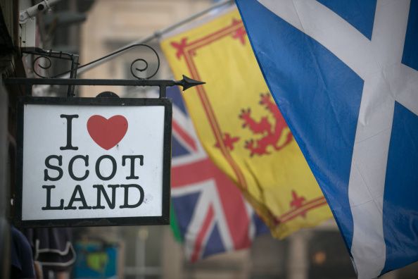 EDINBURGH, SCOTLAND - SEPTEMBER 19: The Saltire flag flies next to the Royal Standard of Scotland and the Union Flag above a gift shop in central Edinburgh on September 19, 2014 in Edinburgh, Scotland. The majority of Scottish people have today voted 'No' in the referendum and Scotland will remain within the historic union of countries that make up the United Kingdom. (Photo by Matt Cardy/Getty Images)