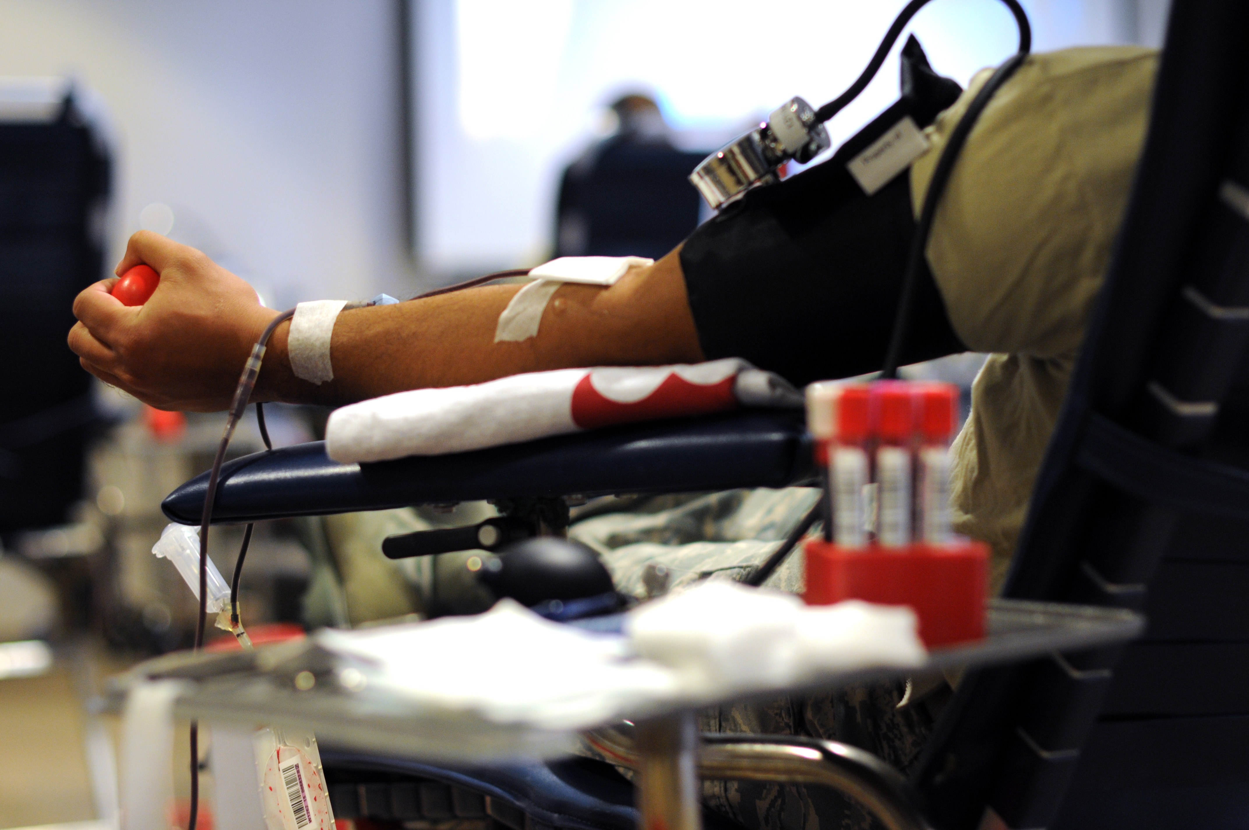 A U.S. Air Force Airman from the New Jersey Air National Guard's 177th Fighter Wing squeezes an object while giving blood during a blood drive on Atlantic City Air National Guard Base, N.J., Aug. 29, 2015. The objects are given out for donors to squeeze in order to help blood flow. (U.S. Air National Guard photo by Senior Airman Shane S. Karp/Released)