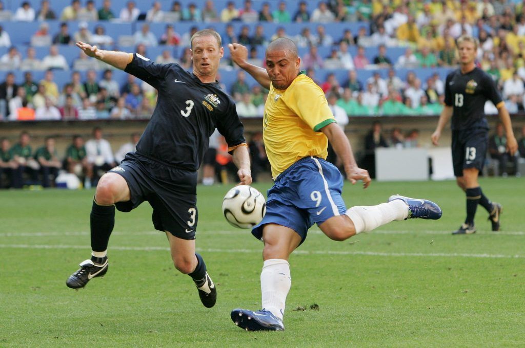 MUNICH, GERMANY - JUNE 18: Ronaldo of Brazil has a shot on goal as Craig Moore of Australia tries to block during the FIFA World Cup Germany 2006 Group F match between Brazil and Australia at the Stadium Munich on June 18, 2006 in Munich, Germany. (Photo by Phil Cole/Getty Images)