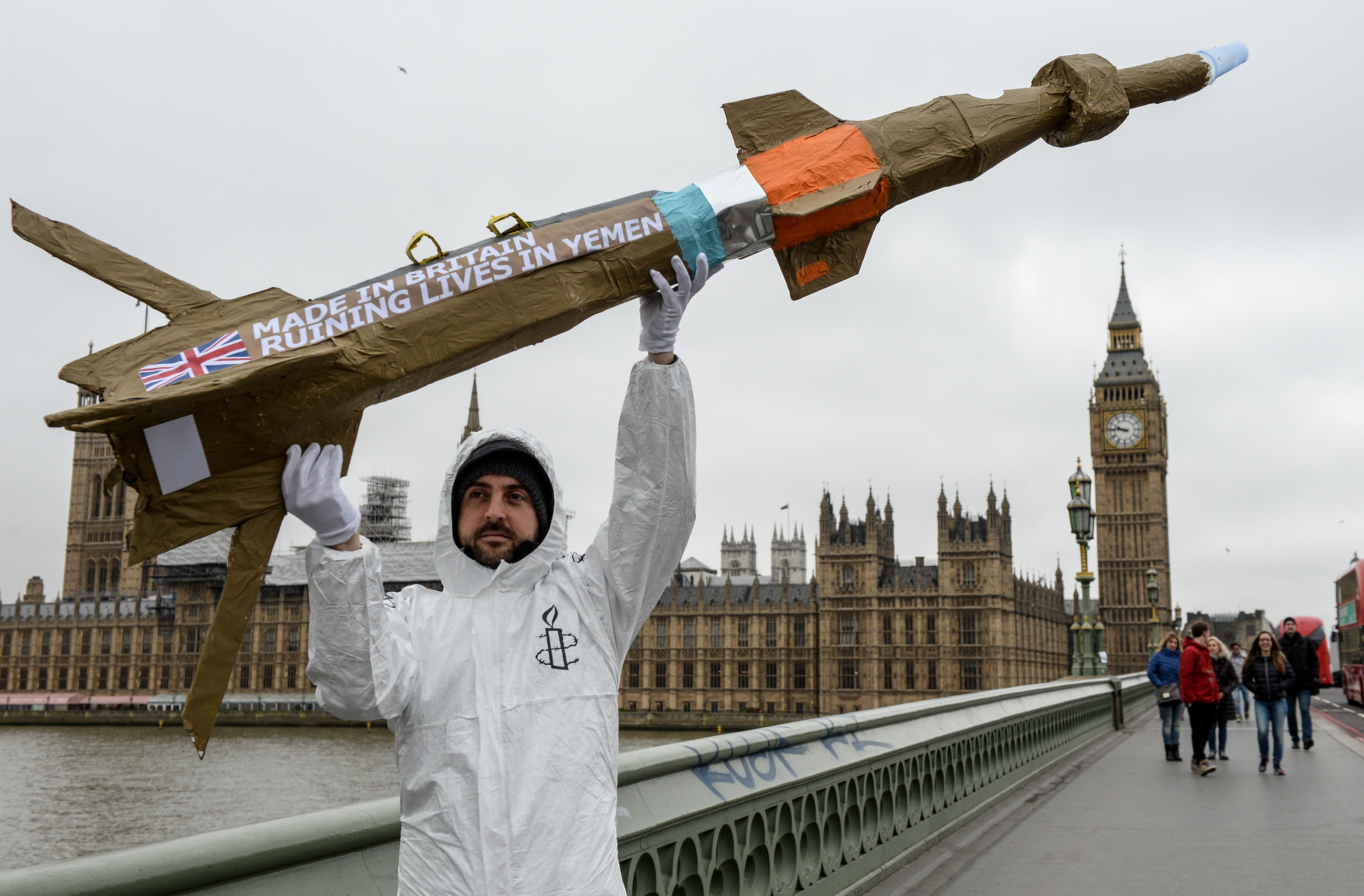 LONDON, ENGLAND - MARCH 18: Amnesty International activists march with homemade replica missiles bearing the message 'Made in Britain, destroying lives in Yemen' across Westminster Bridge, past Parliament and to Downing Street during a protest over UK arms sales to Saudi Arabia on March 18, 2016 in London, England. The missiles are replicas of the 500lb 'Paveway-IV' weapon which are currently used by Saudi Arabia's UK supplied Eurofighter Typhoon war planes. (Photo by Chris Ratcliffe/Getty Images)