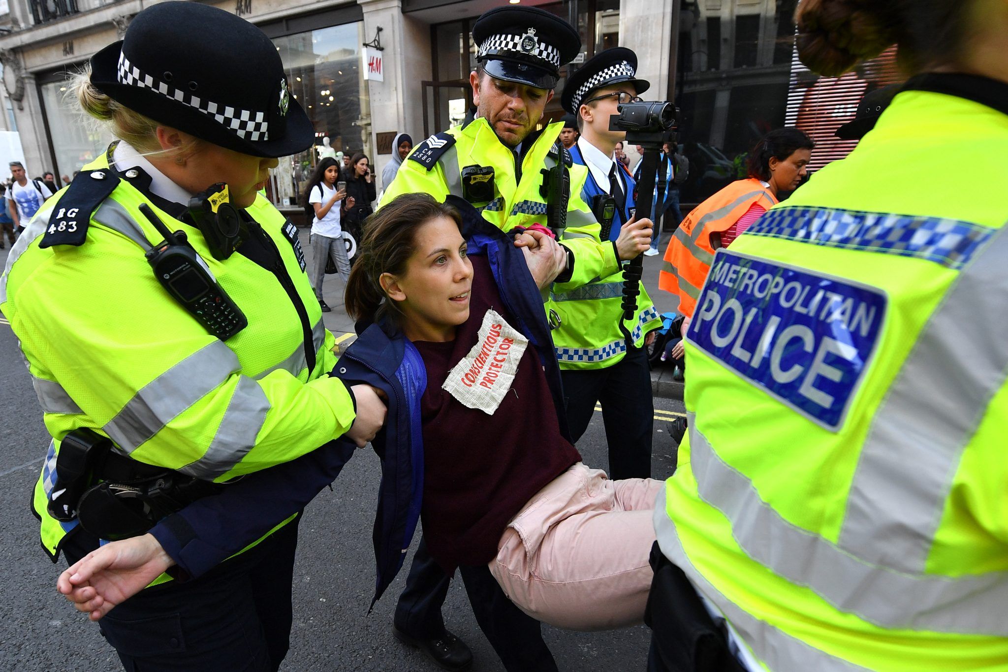 Metropolitan Police officers arrest an Extinction Rebellion protester
