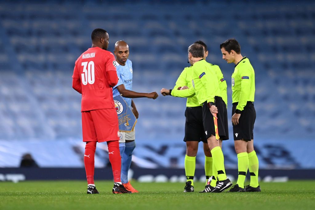 Fernandinho fist-bumping the referee