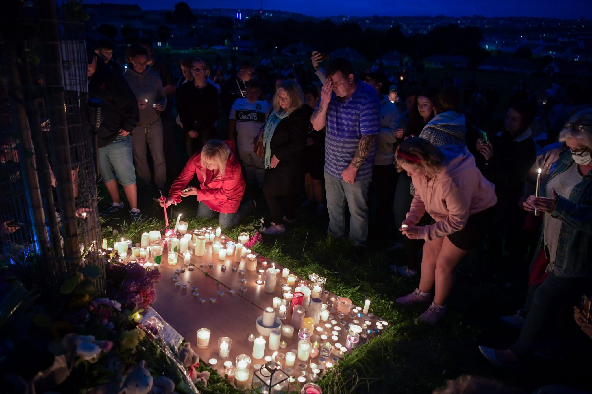 Members of the community hold a vigil for the victims of Plymouth gun attack