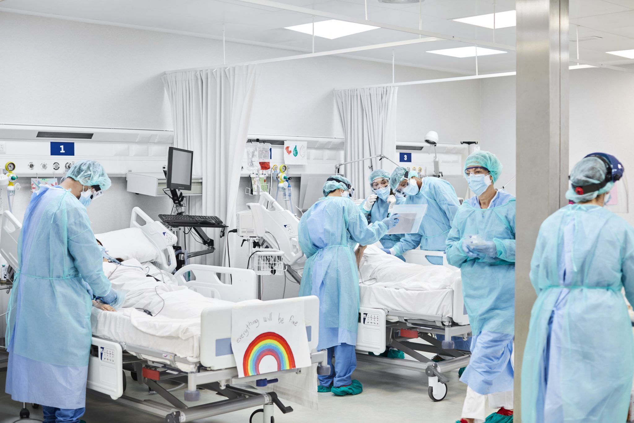 Medical professionals operating on patient in ICU
