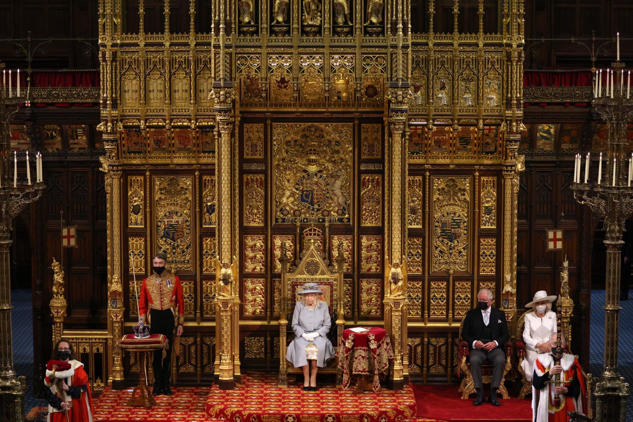Queen Elizabeth II in the House of Lord's Chamber with Prince Charles, Prince of Wales and Camilla, Duchess of Cornwall seated (R) during the State Opening of Parliament at the House of Lords on May 11, 2021 in London, England. (Photo by Chris Jackson - WPA Pool/Getty Images)
