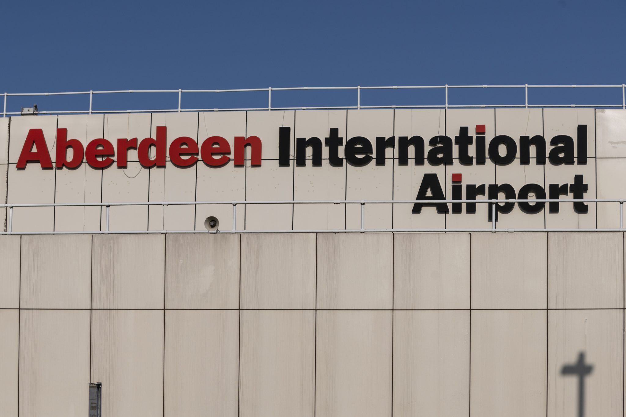 A large sign on the outside of the terminal building of Aberdeen International Airport in Scotland.